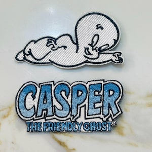 May include: Two embroidered patches featuring Casper the Friendly Ghost. The first patch is a white outline of Casper with a blue gradient. The second patch is a blue gradient of the text "Casper The Friendly Ghost".