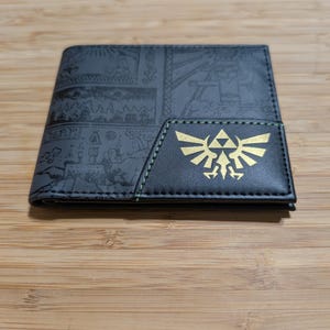 Cartera plegable con imágenes antiguas del Ala de la Trifuerza de Zelda
