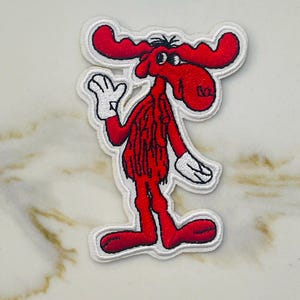 May include: Red cartoon moose with white outlines, wearing a red shirt and white gloves, waving with its right hand.