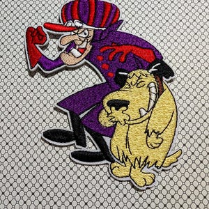 May include: Embroidered patch featuring a cartoon villain in a purple coat and hat with red accents, and a smiling yellow dog. The patch has a white border and is on a patterned background.