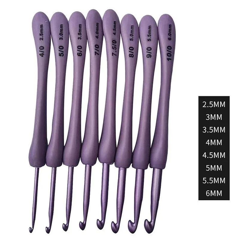 May include: A set of eight lavender crochet hooks with silver metal tips. Each hook is labeled with a size in millimeters, ranging from 2.5mm to 6.0mm. The hooks are arranged vertically, with the sizes clearly displayed.