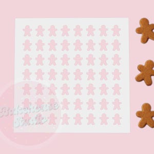 Peut inclure: Une feuille d'autocollants roses en forme de bonhommes en pain d'épices avec trois biscuits en pain d'épices sur fond rose. Les autocollants sont disposés en grille. Les biscuits sont bruns.