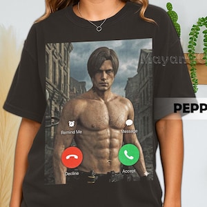 May include: Dark grey t-shirt with a graphic of a man's torso, presented as a phone call interface. The screen shows "Remind Me" and "Message", with "Decline" and "Accept" buttons in a call screen design.