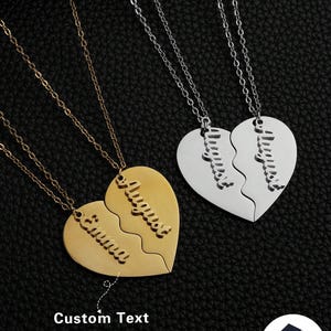 May include: Two heart-shaped pendant necklaces, one gold-toned and one silver-toned, each split into two pieces. The gold necklace has the names "Emma" and "August" engraved. The silver necklace also has names engraved. The text "Custom Text" is also visible.