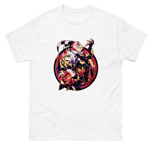May include: White t-shirt with a colorful illustration of four cartoon characters in a circle. The characters are a red demon, a black demon, a white demon, and a yellow demon. The characters are all smiling and have horns.