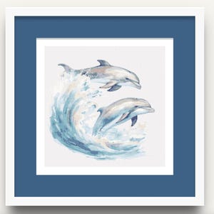 May include: Watercolor painting of two dolphins leaping from a wave. The artwork is framed in a white mat and a blue frame. The dolphins are shades of gray and white, and the wave is blue and white.