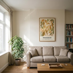 May include: A framed vertical wall art print featuring an abstract watercolor painting of green and gold leaves with the text KOMOREBI JAPANESE the sunlight that filters through the leaves of trees centered below the illustration on a white background.