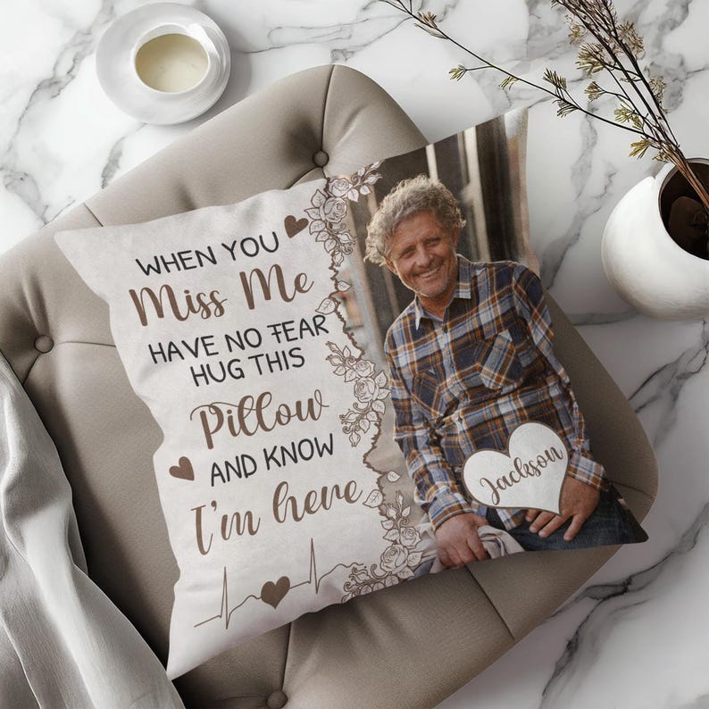 May include: A decorative pillow with a photo of a man and the text "WHEN YOU MISS ME HAVE NO FEAR HUG THIS PILLOW AND KNOW I'M HERE." The pillow has a floral border and a wooden heart with the name "Jackson."