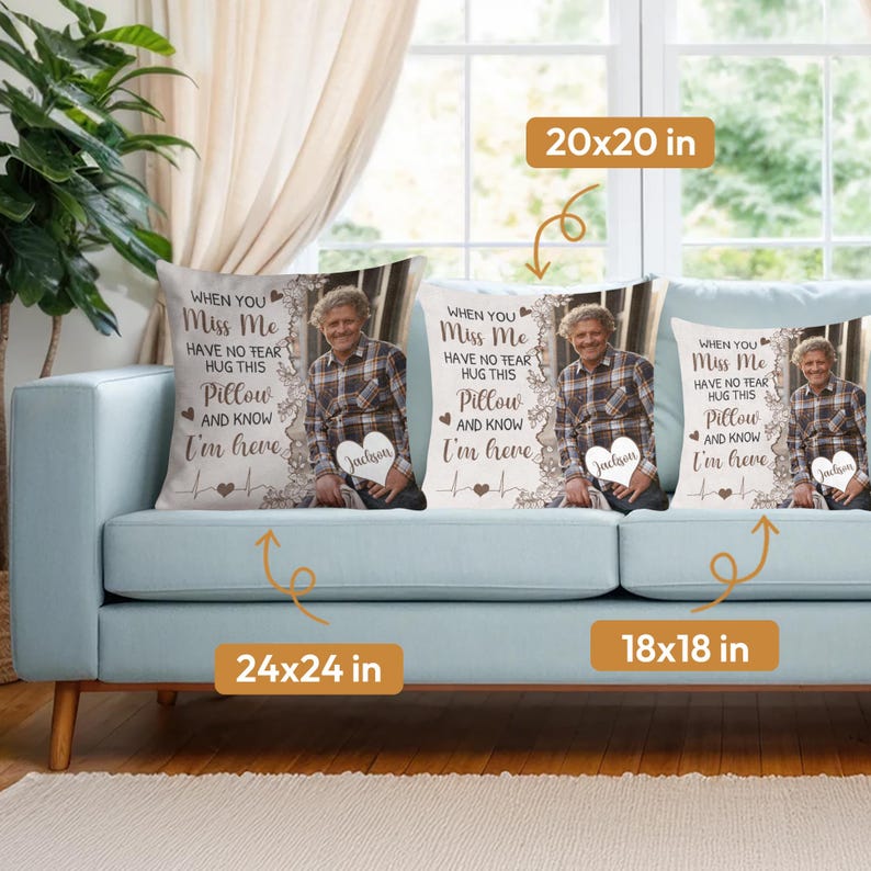 May include: Three decorative throw pillows on a light blue sofa. Each pillow features a photo of a person, the text "WHEN YOU Miss Me HAVE NO FEAR HUG THIS Pillow AND KNOW I'm here", and a name. Sizes are 24x24 in, 20x20 in, and 18x18 in.