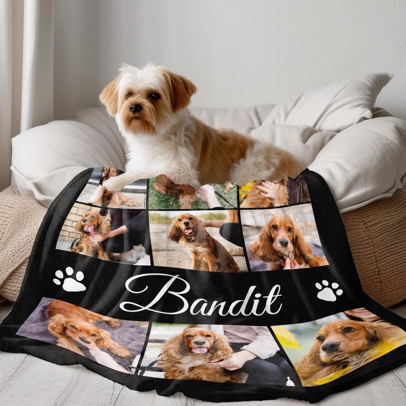 May include: A black fleece blanket featuring a collage of photos of a brown and white dog. The blanket has a black border with white paw prints and the name "Bandit" written in white cursive.
