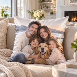 May include: A rectangular throw pillow featuring a printed photograph of a family of four, including a man, a woman, a young boy, a young girl, and a golden retriever dog, set against a scenic landscape background with mountains and water.