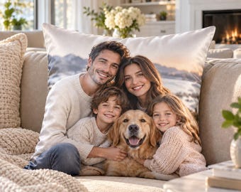 May include: A rectangular throw pillow featuring a printed photograph of a family of four, including a man, a woman, a young boy, a young girl, and a golden retriever dog, set against a scenic landscape background with mountains and water.