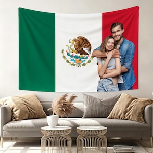 May include: A large wall tapestry featuring the Mexican flag design. The flag is divided into three vertical bands of green, white, and red. The white band displays the Mexican coat of arms. A couple is embracing in front of the red section.