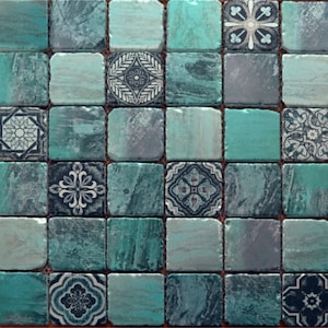 May include: A mosaic tile sheet with a teal and blue colour scheme. The tiles feature a variety of geometric patterns in white and black.