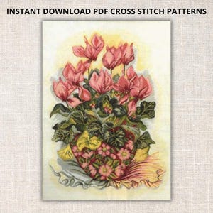 May include: A cross stitch pattern featuring a bouquet of pink cyclamen flowers in a heart-shaped pot with green leaves. The flowers are arranged in a vase with a white and yellow ruffled trim.