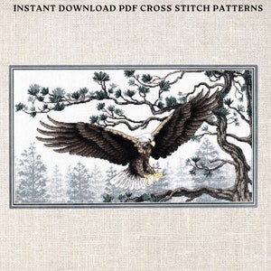 May include: Cross-stitch pattern featuring a detailed image of a bald eagle in flight, with outstretched wings. The eagle is brown and white, set against a backdrop of a forest and trees. The text "INSTANT DOWNLOAD PDF CROSS STITCH PATTERNS" is at the top.