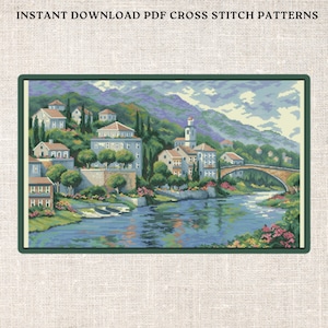 May include: Cross stitch pattern depicting a charming village scene with houses, a bridge, and a river. The houses are white with blue roofs and are set amongst green trees. The river is blue and reflects the sky. The bridge is arched and made of stone. This pattern is ideal for cross stitch enthusiasts who enjoy creating beautiful and intricate artwork.