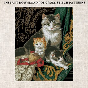 May include: Cross stitch pattern featuring a mother cat and two kittens. The image shows a detailed design with a black background, green and gold accents, and the text "INSTANT DOWNLOAD PDF CROSS STITCH PATTERNS" at the top.
