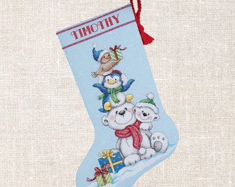 May include: A blue Christmas stocking with the name "TIMOTHY" embroidered on it. The stocking features a penguin, a polar bear, and a bird holding a gift.