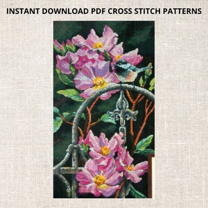 May include: Cross stitch pattern featuring a bluebird perched on a metal trellis with pink flowers. The pattern is for a cross stitch project.