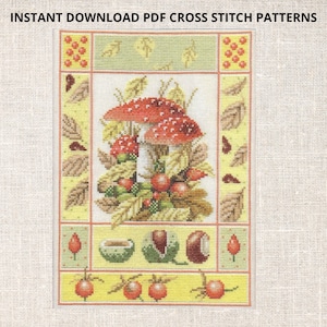 Pode incluir: Padrão de ponto cruz com um cogumelo vermelho e branco rodeado por folhas e bagas. O design inclui uma borda com folhas, bagas e outros elementos de outono. O texto na parte superior diz "INSTANT DOWNLOAD PDF CROSS STITCH PATTERNS".