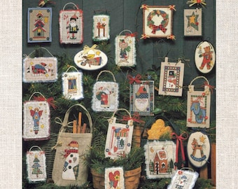 May include: A collection of 18 cross stitch patterns featuring various Christmas ornaments. The ornaments are displayed on a green background with a rustic wooden texture. The patterns include a snowman, a Christmas tree, a Santa Claus, a reindeer, a gingerbread house, and more.