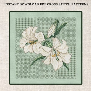 May include: Cross stitch pattern featuring two white lilies with green leaves and stems on a green background with a geometric pattern.
