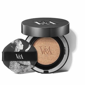 May include: A black and silver compact foundation with a cushion applicator. The compact has a black and white image of a woman with the text "V&A" on the front.