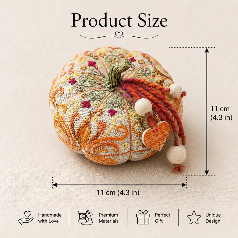 Size reference infographic for the Pumpkin Heart of Autumn pincushion sampler cross stitch kit. The finished pumpkin pincushion measures 11 × 11 cm (4.3 × 4.3 inches). Decorative embroidery, ceramic stem, heart charm, and dimensional construction are shown clearly to help buyers understand the finished project size.