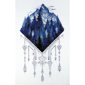 May include: A blue and white cross stitch pattern featuring a mountain range with trees and a geometric design. The design is in a diamond shape with a geometric pattern hanging from the bottom.