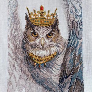 Close-up of Royal Owl counted cross stitch with Preciosa Czech beads and golden crown details on white Aida 14 fabric.