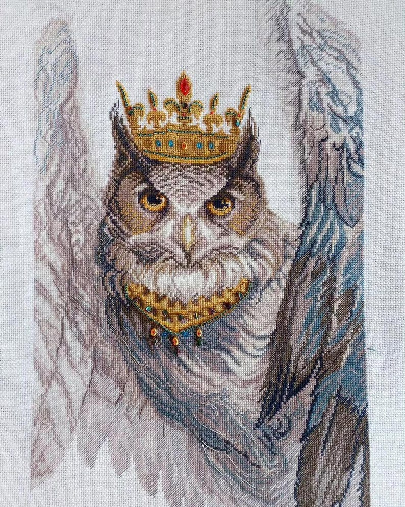 Close-up of Royal Owl counted cross stitch with Preciosa Czech beads and golden crown details on white Aida 14 fabric.