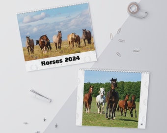 May include: Two calendars featuring horses. The first calendar has a photo of a group of horses in a field. The second calendar has a photo of a group of horses in a field. Both calendars have the text "Horses 2024" printed on them.