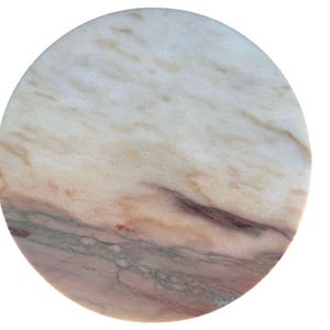 May include: A circular marble coaster with a natural, veined pattern. The coaster displays a mix of white, beige, pink, and grey tones, creating a unique design. Suitable for protecting surfaces from drink condensation.