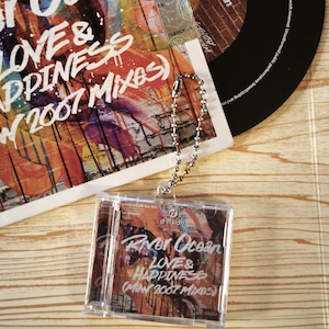 May include: A vinyl record and CD set with the text "River Ocean Love & Happiness (May 2007 Mixes)". The album art features a colourful abstract design. A clear plastic keychain with the same album art is also present.