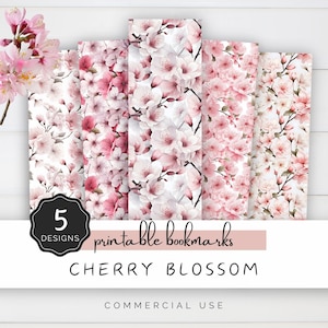 May include: Five printable bookmarks featuring watercolor cherry blossom designs. The bookmarks are in shades of pink and white with a white background. The text "5 Designs" and "Printable Bookmarks" is in a black circle. The text "Cherry Blossom" is in black and the text "Commercial Use" is in gray.