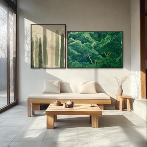 A minimalist living room features two abstract Sage Green Landscape Wall Art pieces above a beige sofa. A wooden table with tea sets and soft light enhances the room’s cozy, natural aesthetic.