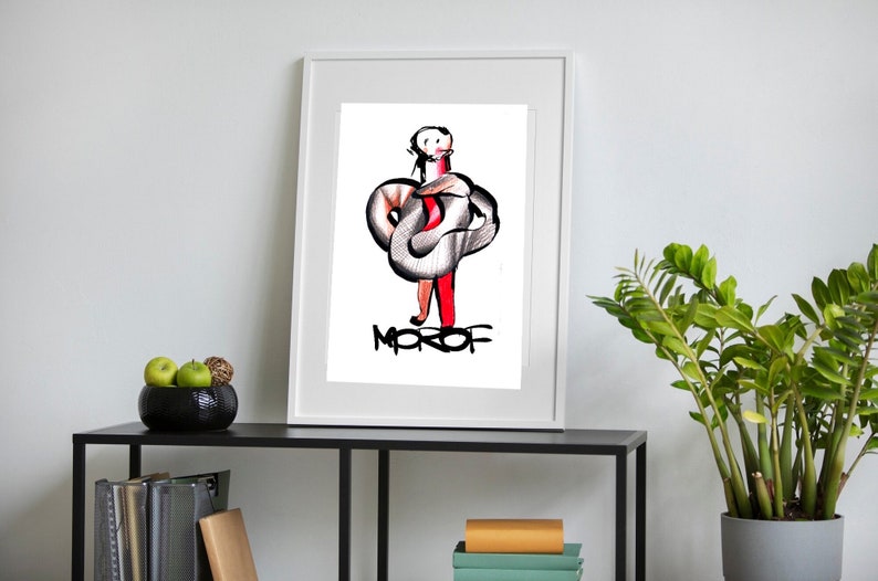 May include: A white framed print of a black and white illustration of a person with a snake wrapped around them. The person is wearing red pants and the snake is gray. The word "MOROF" is written in black below the illustration.