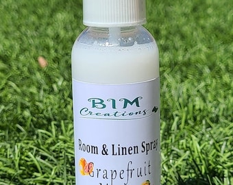 May include: A white plastic bottle with a clear spray nozzle. The bottle is labeled "BIM Creations Room & Linen Spray Grapefruit Mango Hand Crafted in CA 4 oz (114 g) bim_creations".