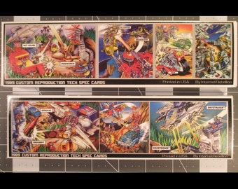 May include: Two sets of vintage trading cards featuring colorful illustrations of robots and vehicles in action scenes. The cards are labeled "1989 Custom Reproduction Tech Spec Cards" and printed in the USA by InternetRebellion.