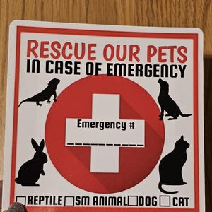 May include: A square sticker with a red cross and the text "RESCUE OUR PETS IN CASE OF EMERGENCY." It features silhouettes of a lizard, dog, rabbit, and cat. Includes checkboxes for pet types and space for an emergency number.