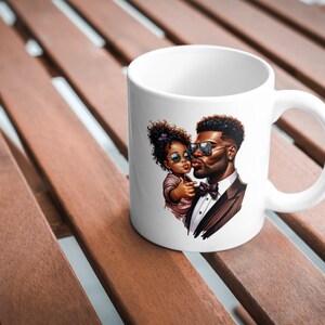 May include: White ceramic mug with a colorful illustration of a father and daughter wearing sunglasses. The father is wearing a suit and bow tie, and the daughter is wearing a pink dress.