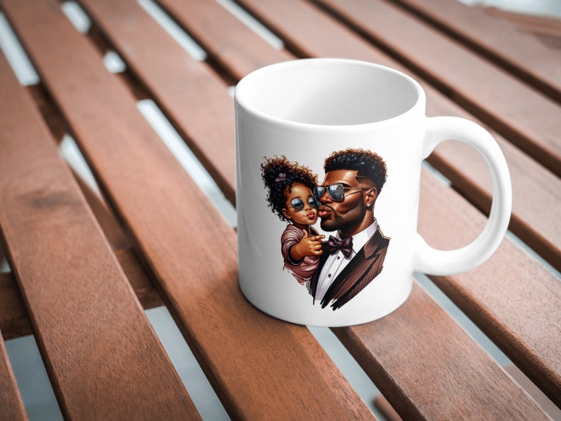 May include: White ceramic mug with a colorful illustration of a father and daughter wearing sunglasses. The father is wearing a suit and bow tie, and the daughter is wearing a pink dress.