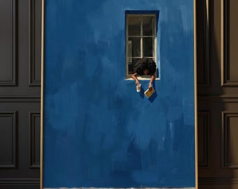 May include: A framed wall art print featuring a vibrant blue wall with a single window. A person with dark curly hair leans out of the window, holding a white coffee cup in one hand and a closed book in the other, above a gray cobblestone base.