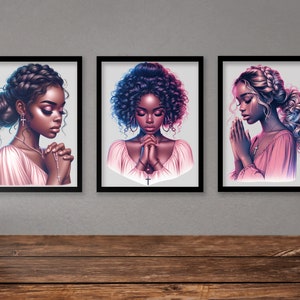 May include: Three framed illustrations of women with dark skin, each with a different hairstyle, wearing pink dresses and praying with their hands clasped together.