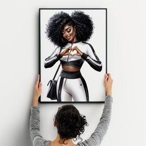 May include: A framed illustration of a woman with dark curly hair wearing a white and black athletic outfit. She is making a heart shape with her hands. The background is white.