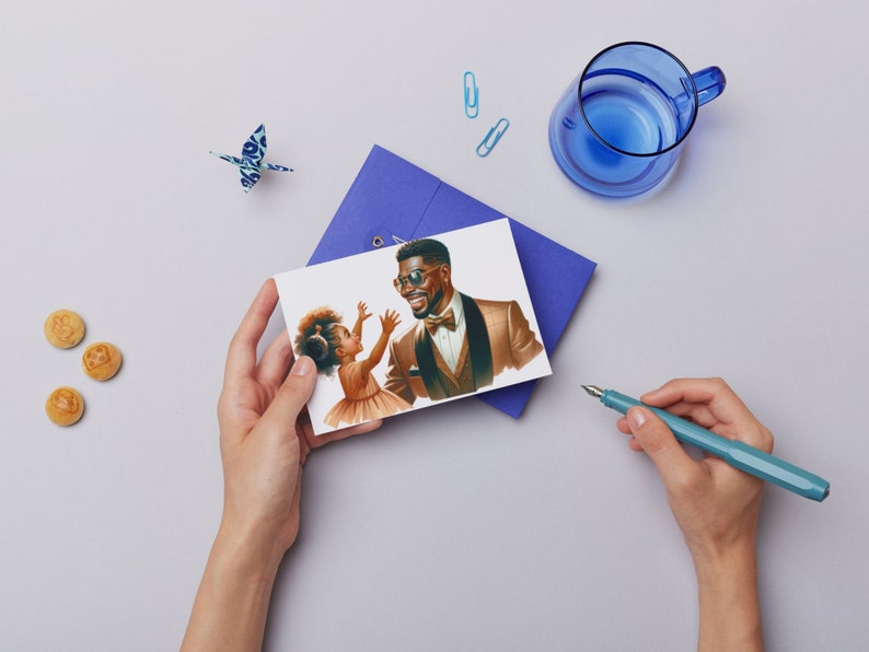 May include: A card with a drawing of a father and daughter. The father is wearing a brown suit and a bow tie. The daughter is wearing a white dress. The father is looking at the daughter and smiling. The daughter is looking at a butterfly.