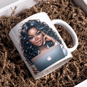May include: White ceramic mug with a colorful illustration of a woman with long black hair wearing glasses and using a laptop. The woman is holding a cup of coffee in her other hand.