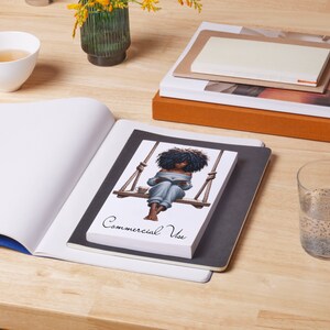 May include: A black and white illustration of a woman sitting on a swing and reading a book. The illustration is on a white background with the text "Commercial Use" printed below it.