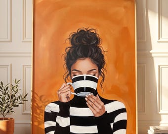 May include: A framed wall art print featuring a painting of a person with dark hair in a messy bun, wearing a black and white horizontal striped turtleneck sweater, holding a matching black and white striped coffee mug against an orange background.